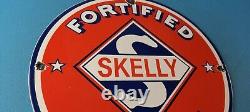 Plaque d'annonce Vintage Skelly Gasoline en porcelaine pour station-service de pompe à essence.
