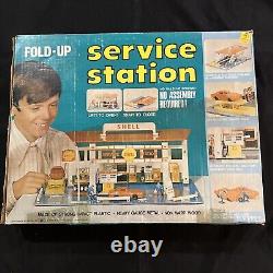 Station-service Shell pliable vintage 1969 avec boîte et jouet de station-service, tel que sur les photos